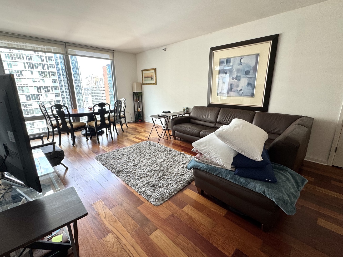 160 East Illinois Street, Unit 1805 Chicago, IL 60611 - Photo 11 of 17 a living room with furniture and wooden floor