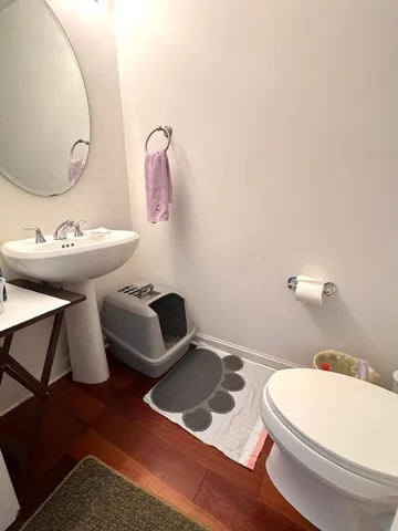 a kitchen with a refrigerator stove and wooden floor