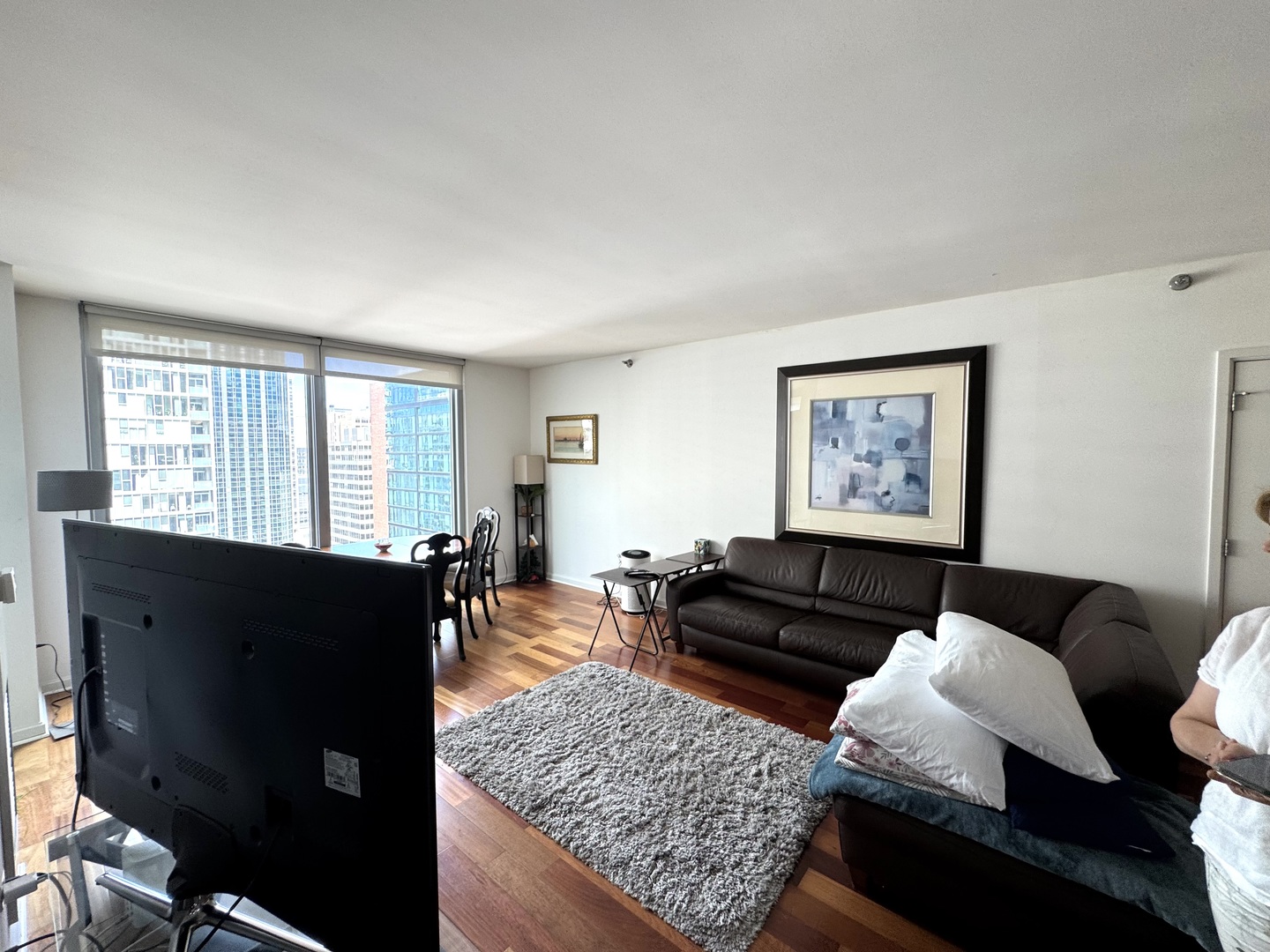 160 East Illinois Street, Unit 1805 Chicago, IL 60611 - Photo 3 of 17 a living room with furniture and wooden floor