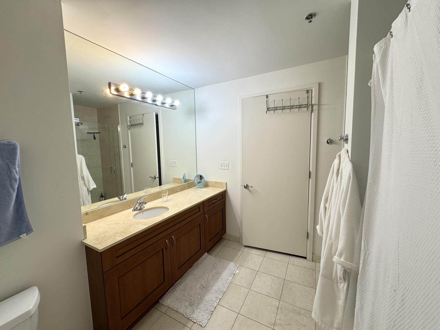 160 East Illinois Street, Unit 1805 Chicago, IL 60611 - Photo 4 of 17 a bathroom with a double vanity sink a mirror and a shower