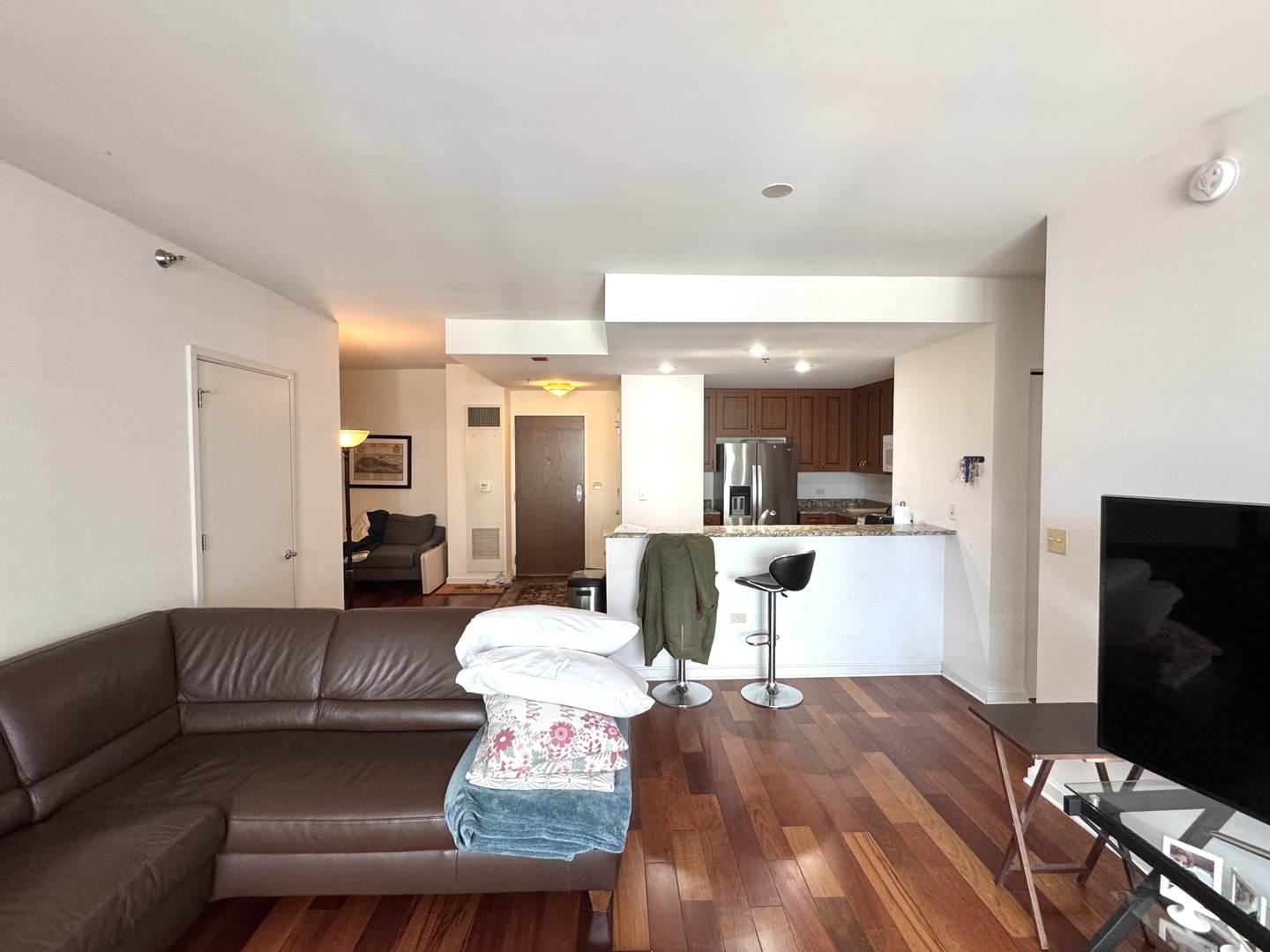 160 East Illinois Street, Unit 1805 Chicago, IL 60611 - Photo 7 of 17 a living room with furniture and a flat screen tv