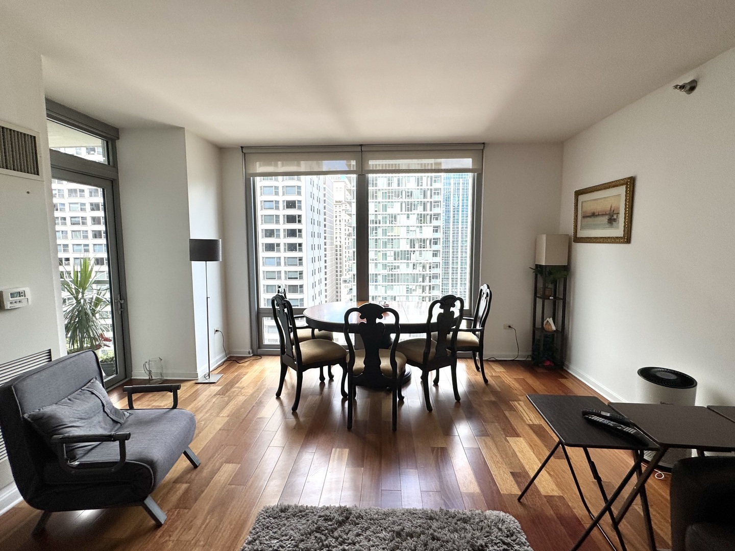 160 East Illinois Street, Unit 1805 Chicago, IL 60611 - Photo 10 of 17 a view of a dining room with furniture and wooden floor