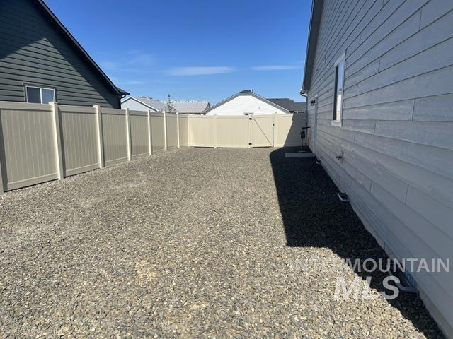 2035 Sumac Avenue Middleton, ID 83644 - Photo 16 of 17 Gravel side yard featuring light-colored privacy fencing with a matching gate