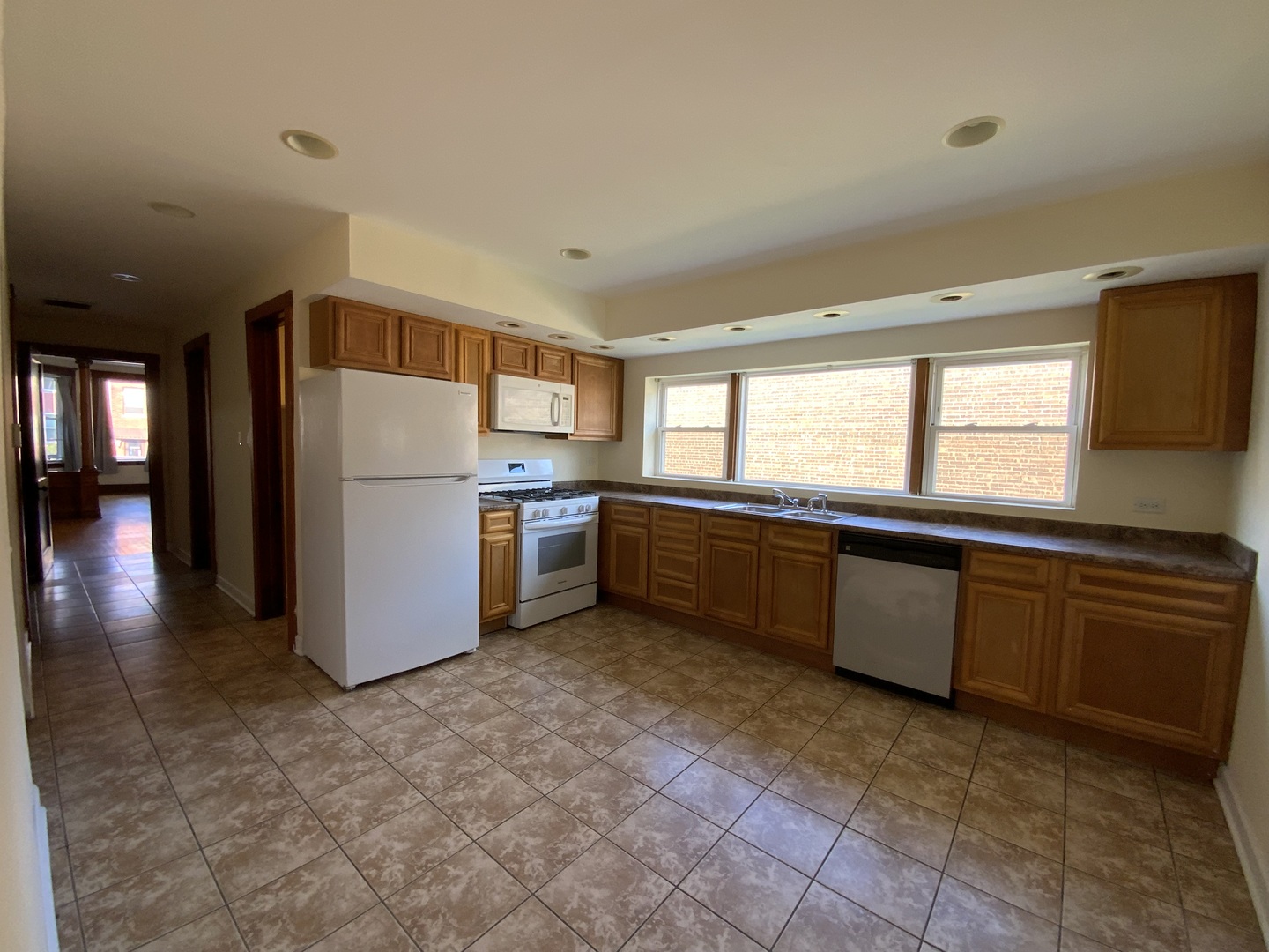 3116 North Elston Avenue, Unit 1 Chicago, IL 60618 - Photo 8 of 16 a kitchen with a refrigerator and a sink