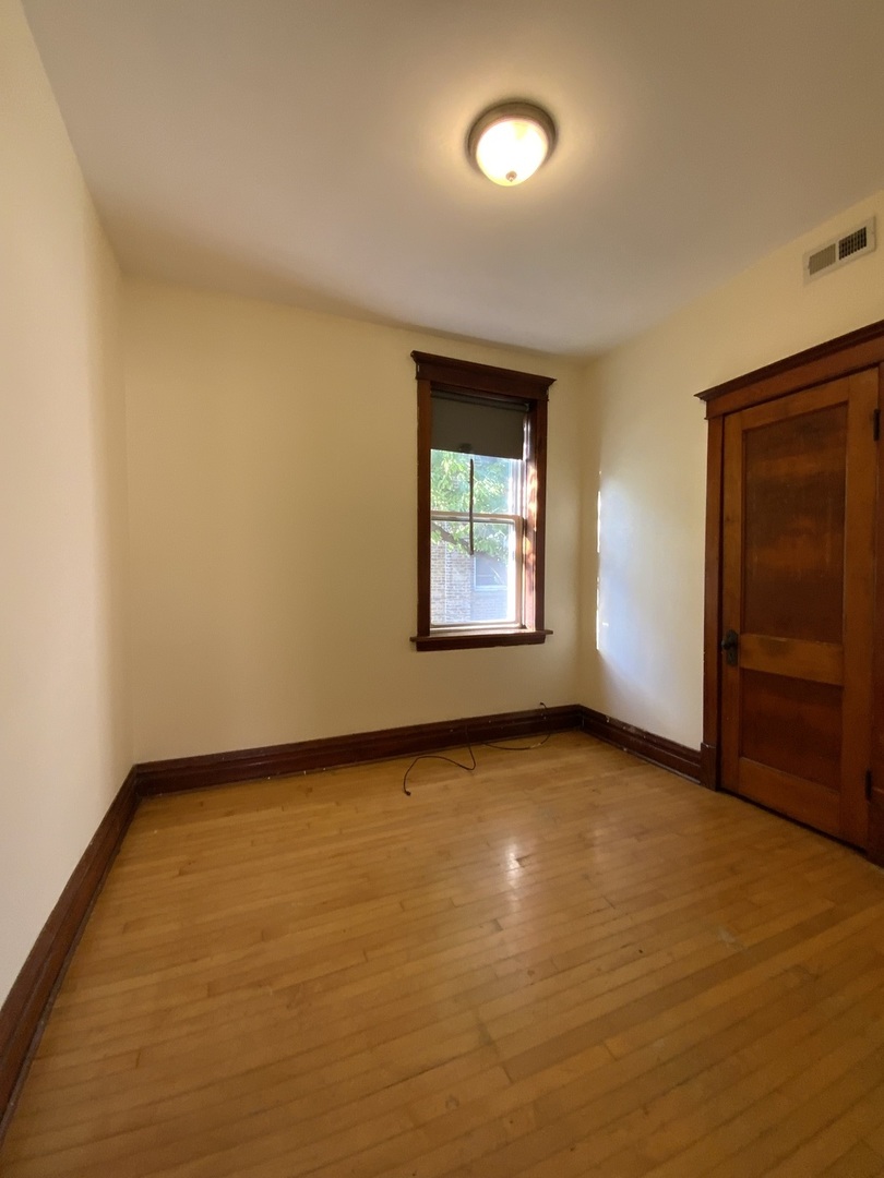3116 North Elston Avenue, Unit 1 Chicago, IL 60618 - Photo 9 of 16 an empty room with windows