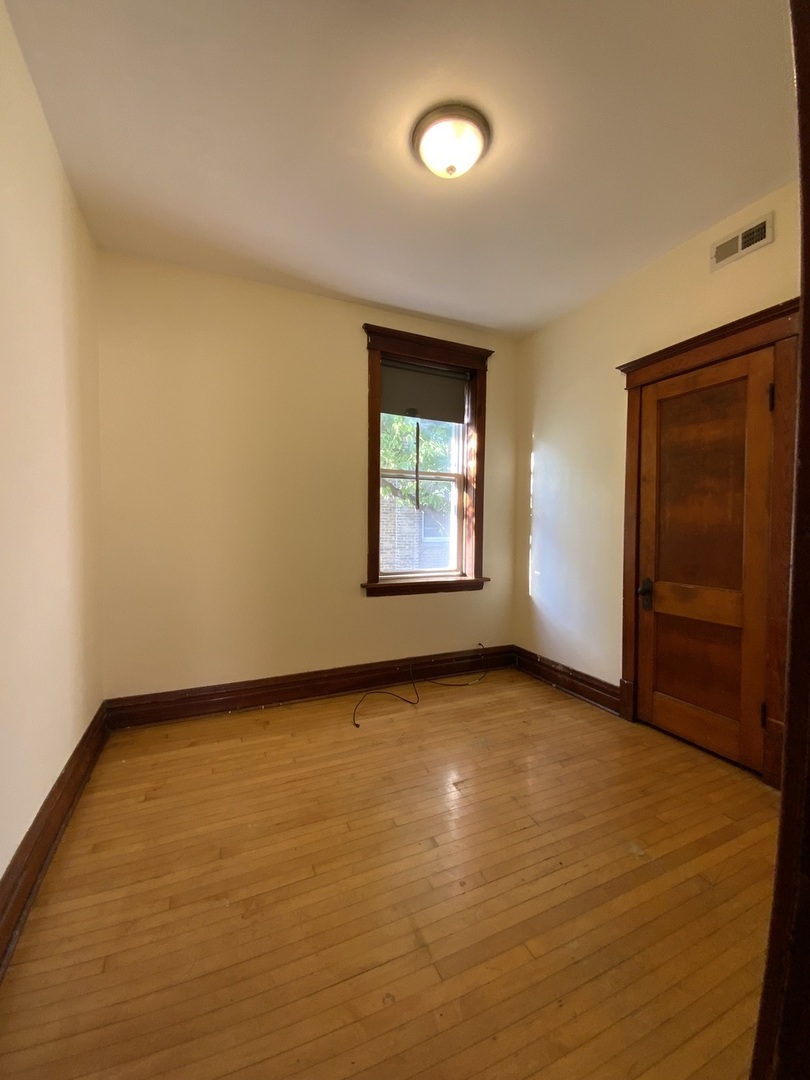 3116 North Elston Avenue, Unit 1 Chicago, IL 60618 - Photo 10 of 16 an empty room with a window