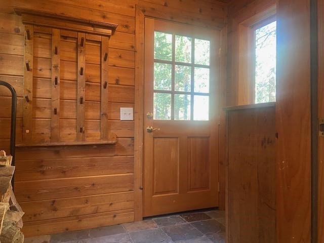 67 Hill Street Mammoth Lakes, CA 93546 - Photo 5 of 24 Doorway to outside featuring wood walls and stone finish flooring