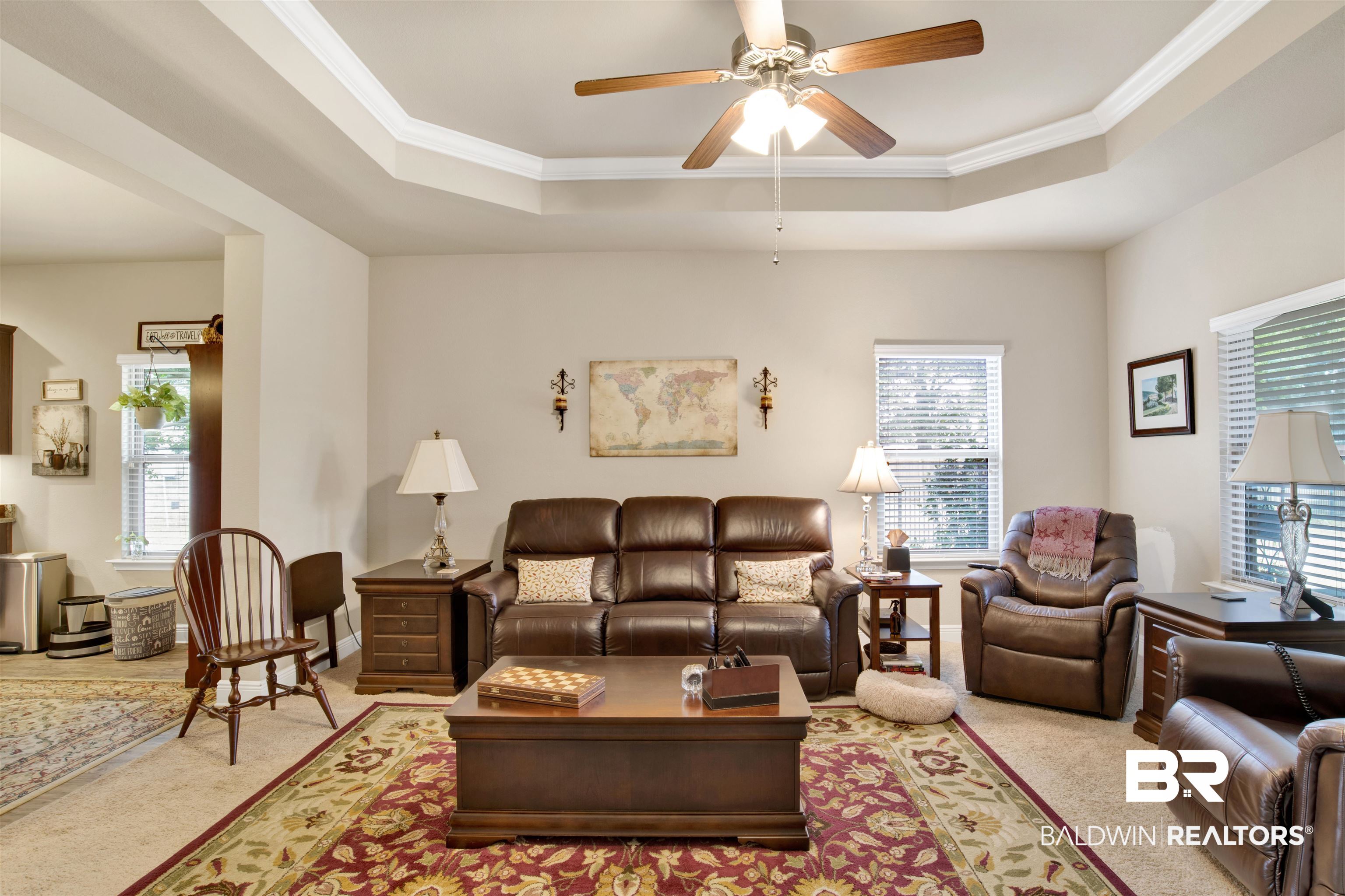 1476 Surrey Loop Foley, AL 36535 - Photo 17 of 31 Living room featuring light carpet, ornamental molding, a raised ceiling, and ceiling fan