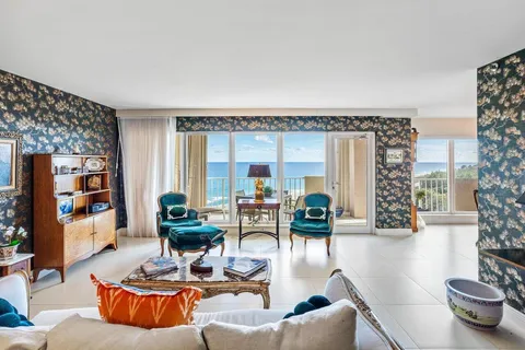 a living room with furniture large window and a table