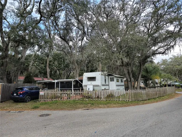 a view of house with outdoor space and car parked