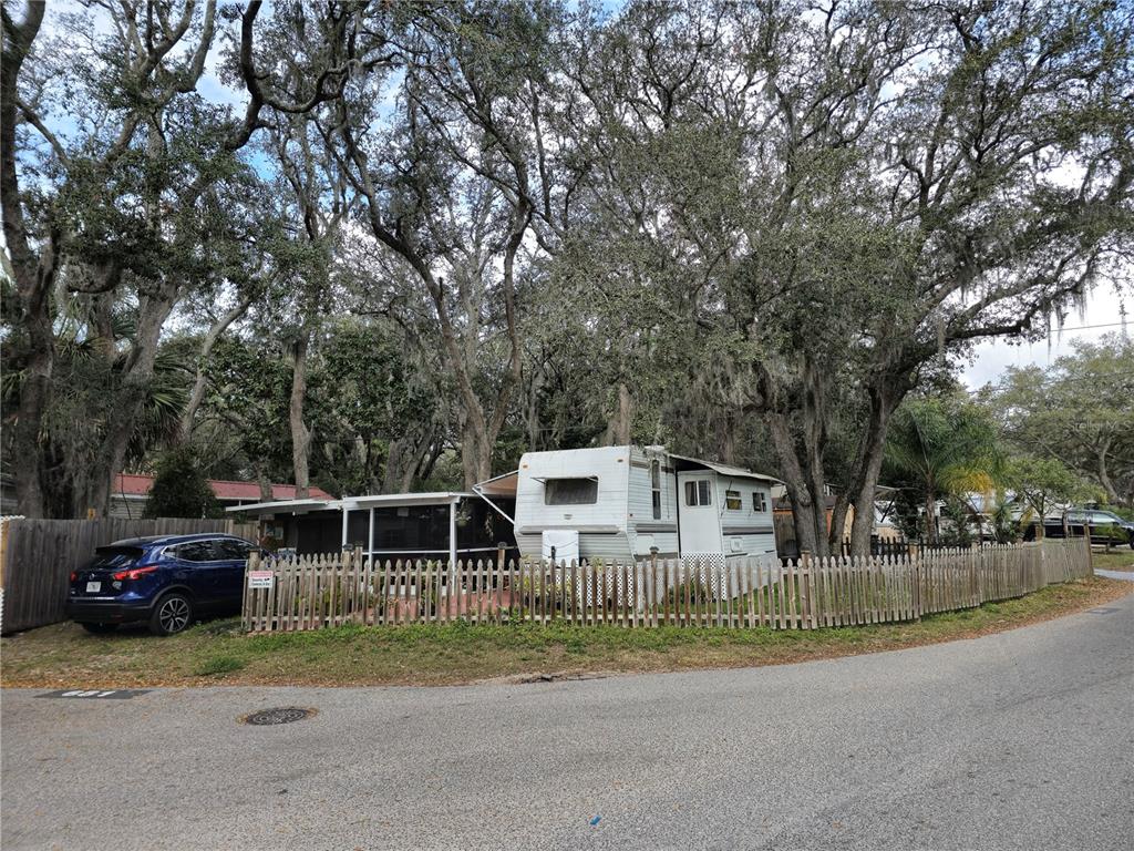 a view of house with outdoor space and car parked