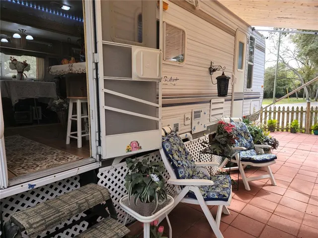 a large bed sitting in a bedroom next to a window