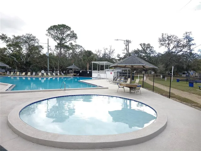 a backyard of a house with barbeque oven and outdoor seating