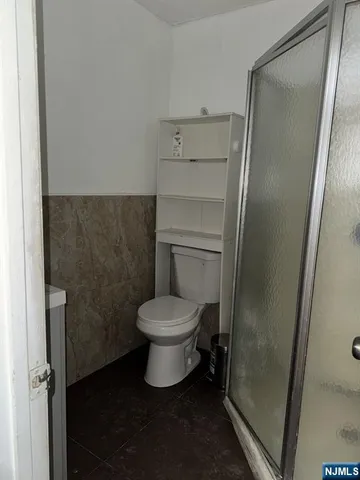 a white toilet sitting next to a sink