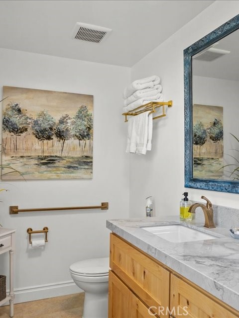 701 Rio Street Red Bluff, CA 96080 - Photo 18 of 72 a bathroom with a granite countertop sink mirror and toilet