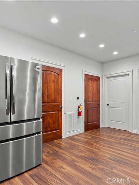 701 Rio Street Red Bluff, CA 96080 - Photo 24 of 72 a view of an empty room with wooden floor and kitchen space