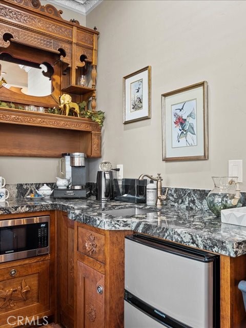 701 Rio Street Red Bluff, CA 96080 - Photo 25 of 72 a kitchen with stainless steel appliances granite countertop a stove a sink and a microwave