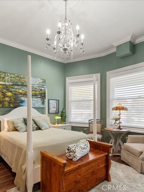 701 Rio Street Red Bluff, CA 96080 - Photo 36 of 72 a bedroom with a large bed and a chandelier