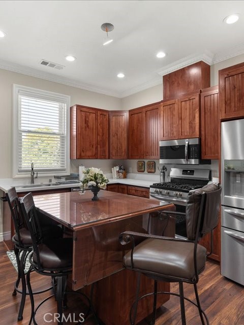 701 Rio Street Red Bluff, CA 96080 - Photo 60 of 72 a kitchen with stainless steel appliances granite countertop a table chairs sink refrigerator and cabinets