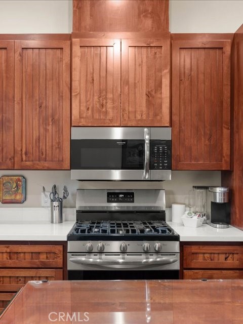 701 Rio Street Red Bluff, CA 96080 - Photo 61 of 72 a kitchen with wooden cabinets and a stove top oven