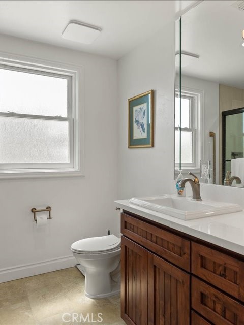 701 Rio Street Red Bluff, CA 96080 - Photo 68 of 72 a bathroom with a granite countertop sink mirror vanity and toilet