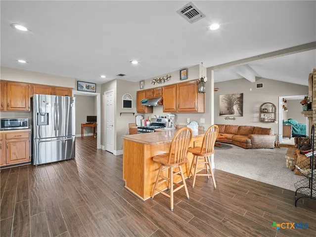 a view of kitchen dining space with furniture and wooden floor