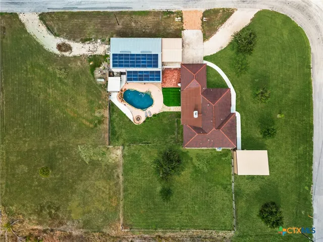 an aerial view of residential houses with outdoor space