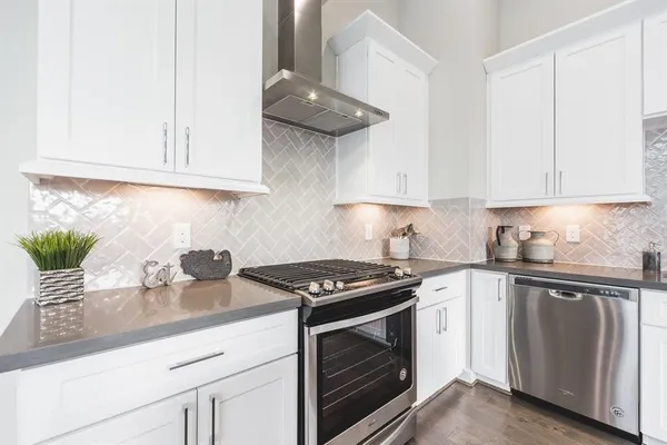 a kitchen with stainless steel appliances granite countertop a sink stove and cabinets