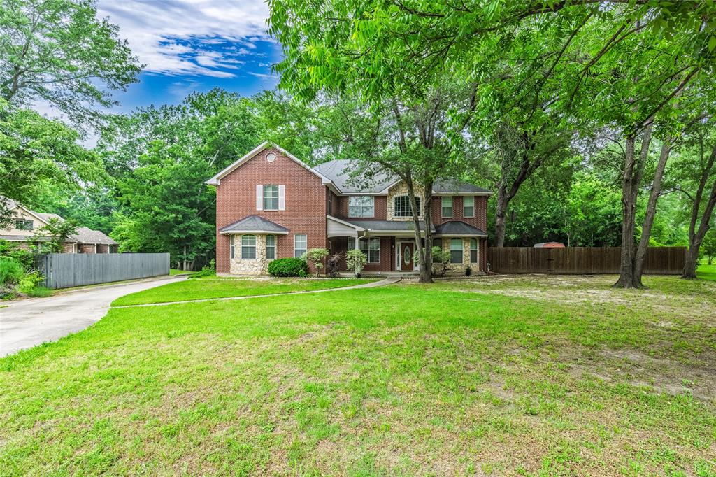 2012 Creekview Drive Commerce, TX 75428 - Photo 1 of 1 a front view of a house with a yard and trees