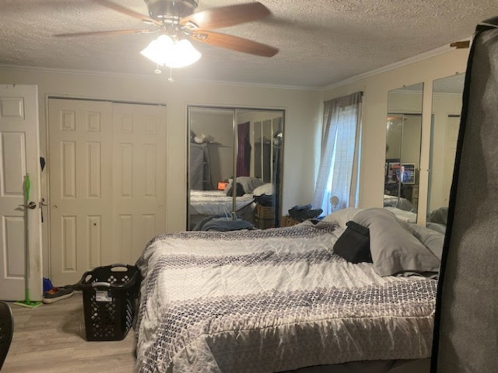 97119 Diamond Street Yulee, FL 32097 - Photo 5 of 6 a bedroom with a bed and a chandelier