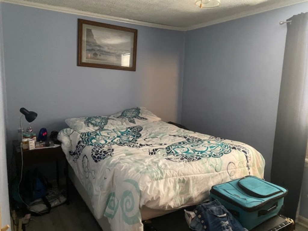 97119 Diamond Street Yulee, FL 32097 - Photo 6 of 6 a bedroom with a bed and wooden floor