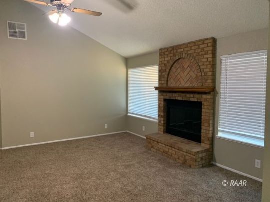 316 West Felspar Avenue Ridgecrest, CA 93555 - Photo 8 of 16 a living room with a fireplace
