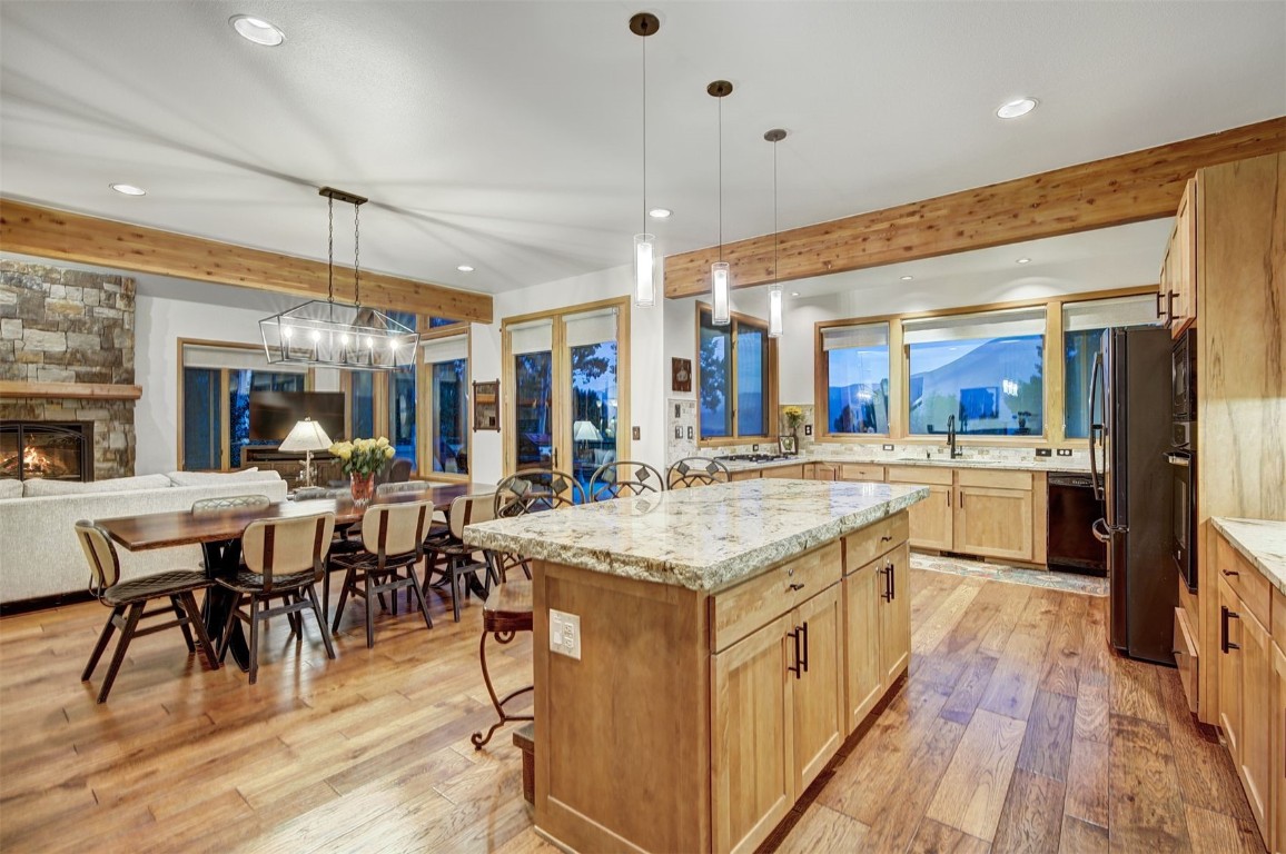 2210 Hamilton Creek Road Silverthorne, CO 80498 - Photo 14 of 50 a open kitchen with stainless steel appliances granite countertop table chairs sink and cabinets