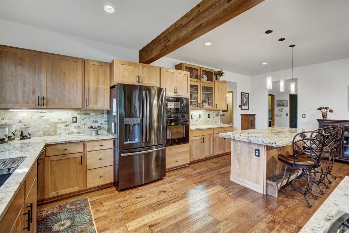 2210 Hamilton Creek Road Silverthorne, CO 80498 - Photo 17 of 50 a kitchen with stainless steel appliances kitchen island granite countertop a stove refrigerator and cabinets