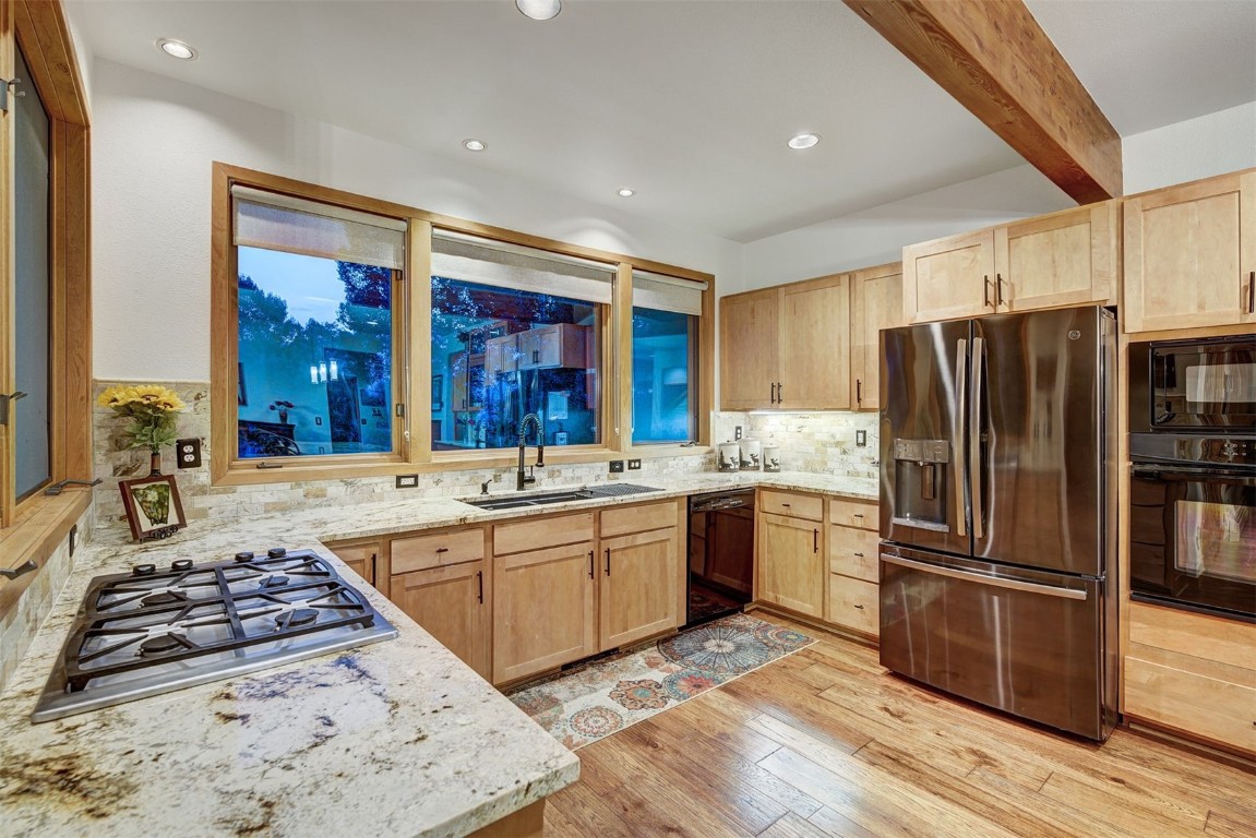 2210 Hamilton Creek Road Silverthorne, CO 80498 - Photo 18 of 50 a kitchen with stainless steel appliances granite countertop a stove and a refrigerator