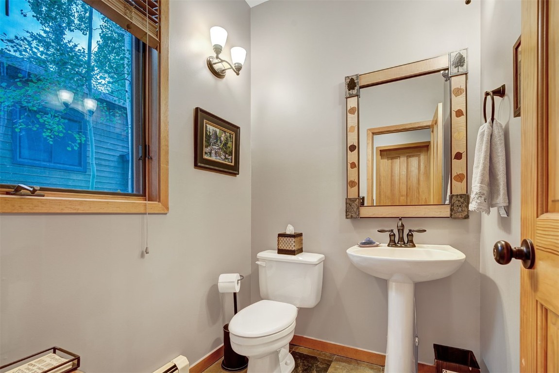 2210 Hamilton Creek Road Silverthorne, CO 80498 - Photo 19 of 50 a bathroom with a toilet sink and mirror