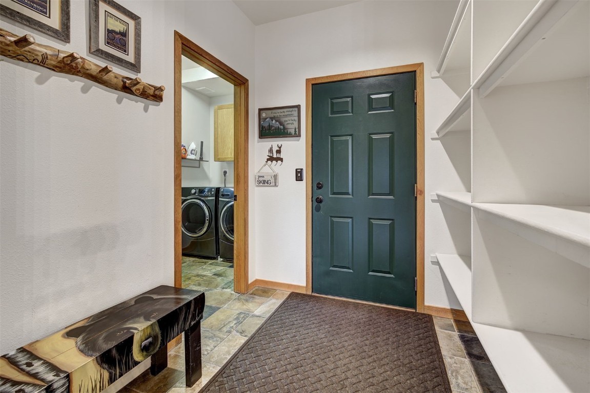 2210 Hamilton Creek Road Silverthorne, CO 80498 - Photo 20 of 50 a view of a hallway with wooden floor and staircase