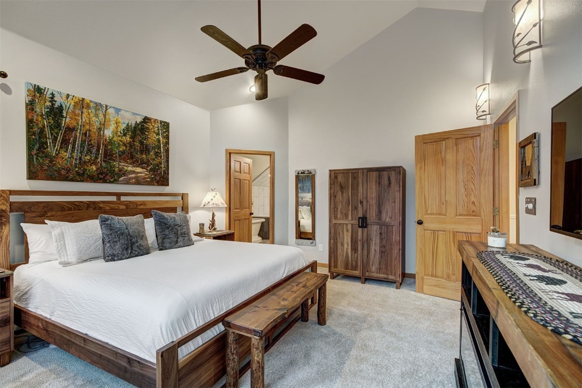 2210 Hamilton Creek Road Silverthorne, CO 80498 - Photo 29 of 50 a bedroom with a bed and a chandelier