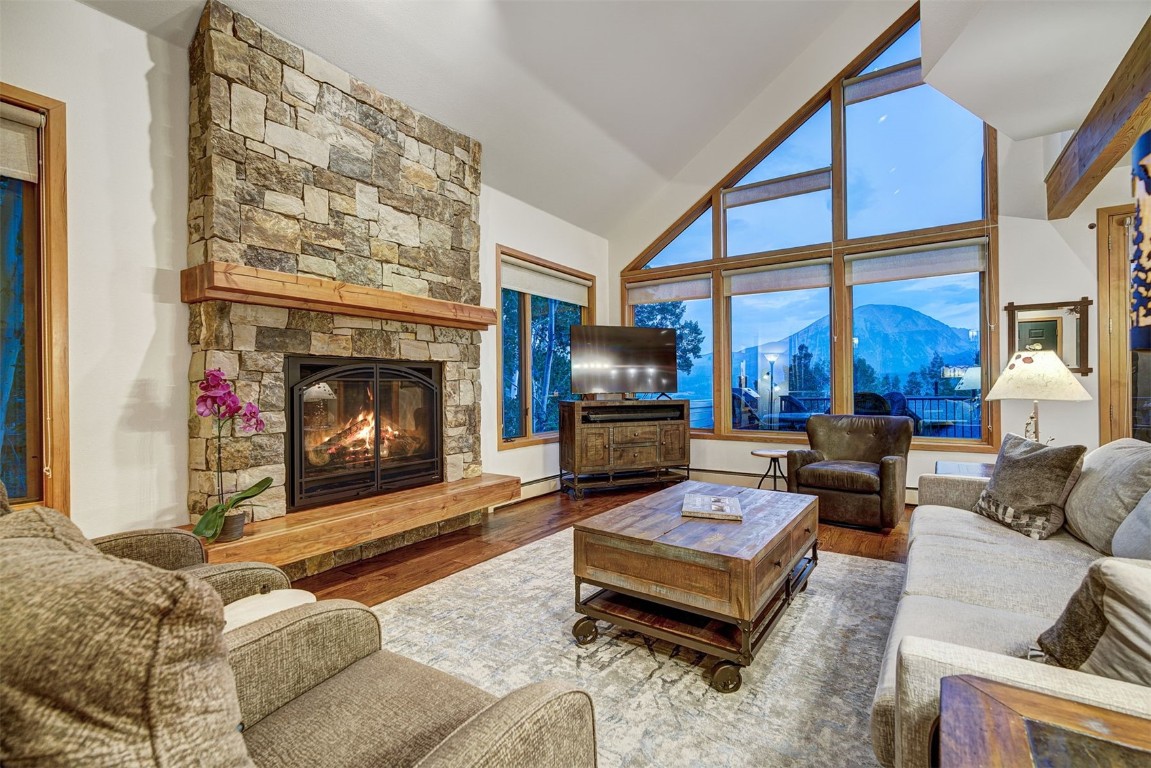 2210 Hamilton Creek Road Silverthorne, CO 80498 - Photo 3 of 50 a living room with furniture a fireplace and a flat screen tv