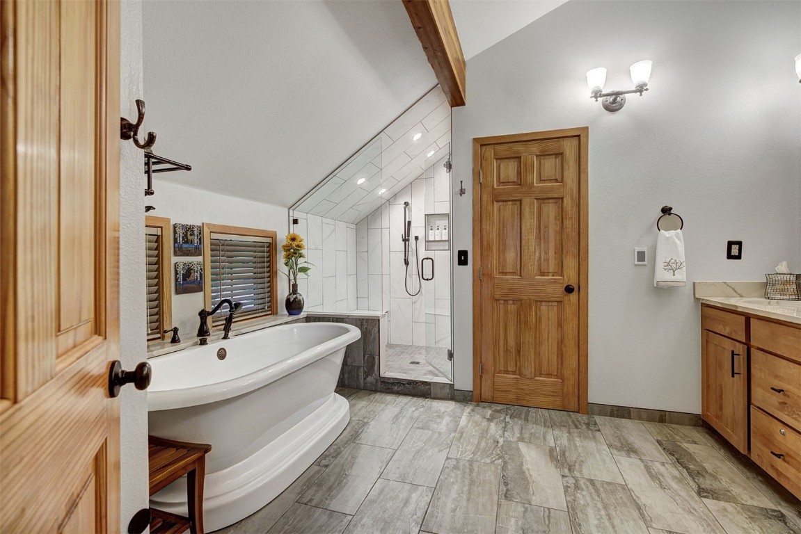 2210 Hamilton Creek Road Silverthorne, CO 80498 - Photo 31 of 50 a bathroom with a sink a mirror and a bathtub