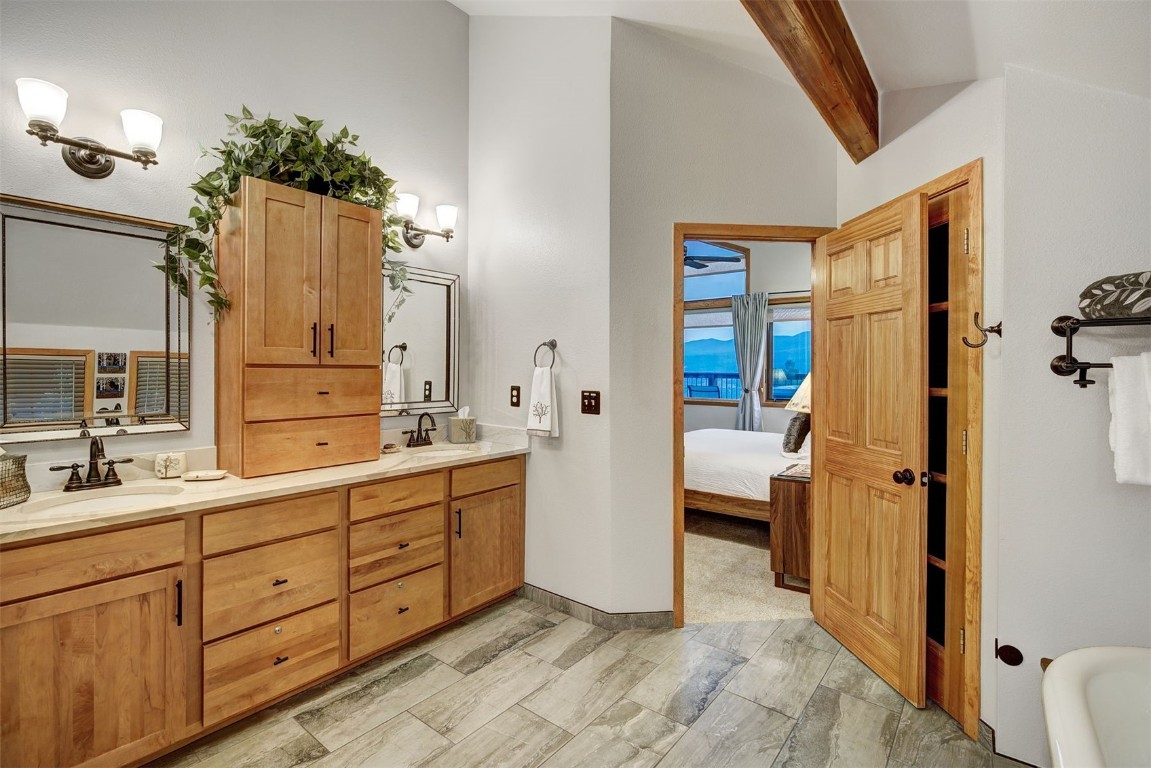 2210 Hamilton Creek Road Silverthorne, CO 80498 - Photo 32 of 50 a bathroom with a double vanity sink mirror and shower