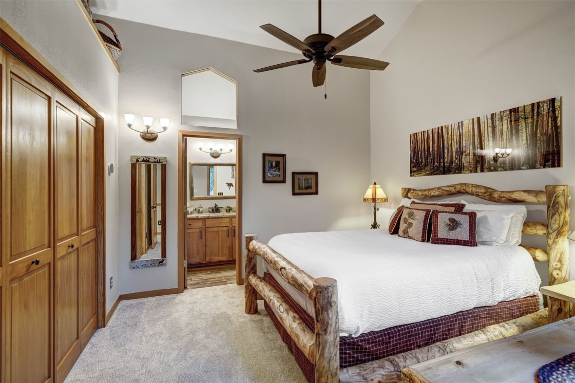 2210 Hamilton Creek Road Silverthorne, CO 80498 - Photo 33 of 50 a bedroom with a bed and a chandelier