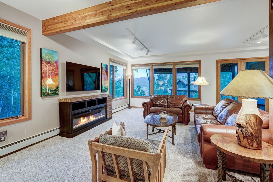 2210 Hamilton Creek Road Silverthorne, CO 80498 - Photo 36 of 50 a living room with fireplace furniture and a flat screen tv