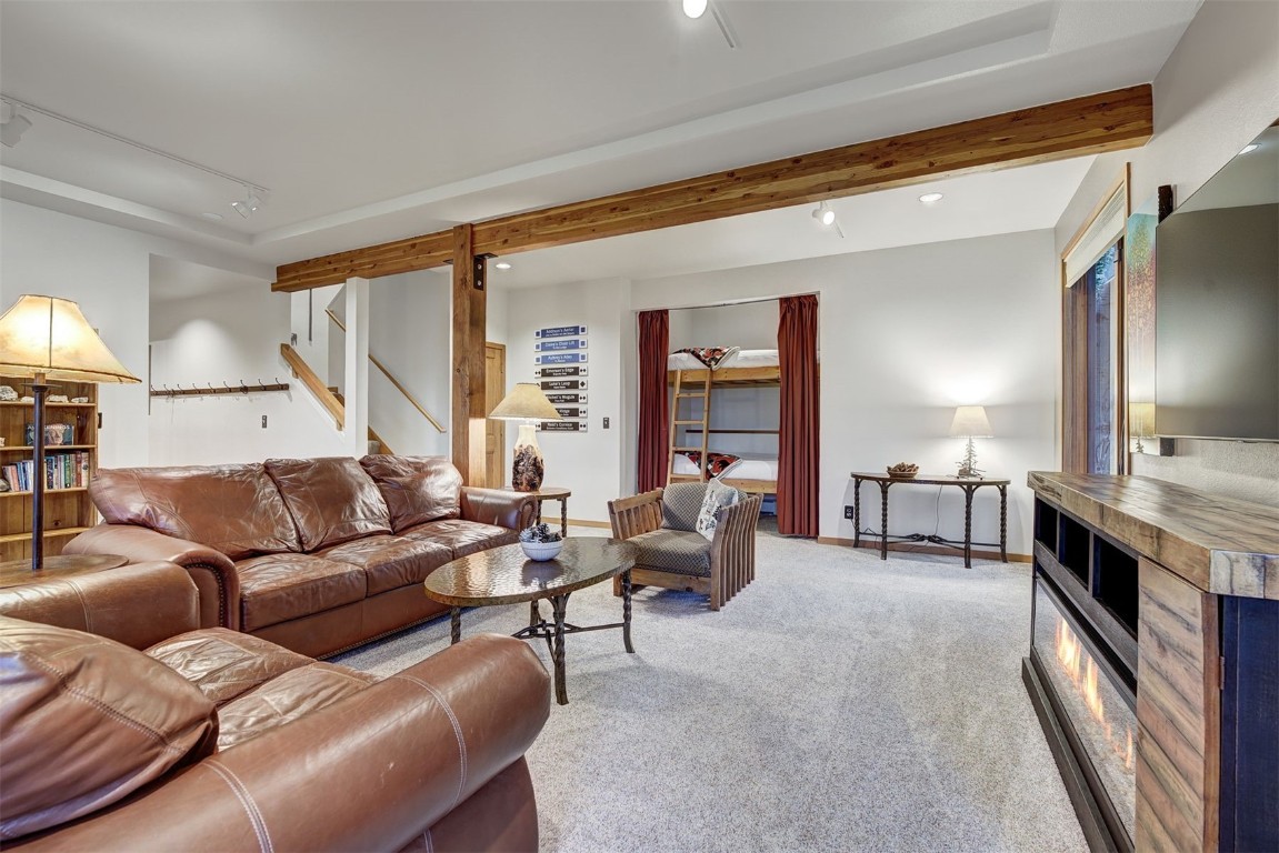 2210 Hamilton Creek Road Silverthorne, CO 80498 - Photo 37 of 50 a living room with furniture and a fireplace