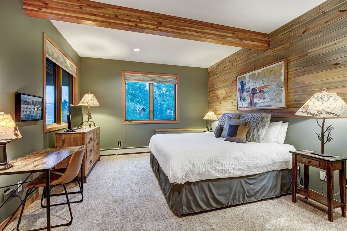 2210 Hamilton Creek Road Silverthorne, CO 80498 - Photo 39 of 50 a bedroom with a bed and a chandelier