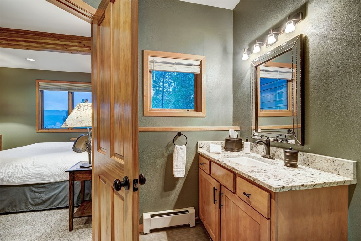 2210 Hamilton Creek Road Silverthorne, CO 80498 - Photo 41 of 50 a bathroom with a granite countertop sink and a mirror