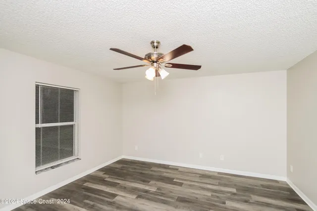 an empty room with closet and windows