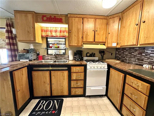 a kitchen with stainless steel appliances a refrigerator and a stove