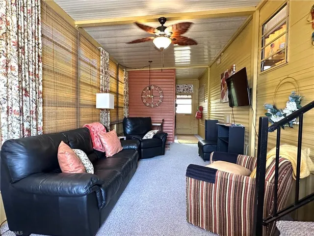 a living room with furniture fireplace and flat screen tv