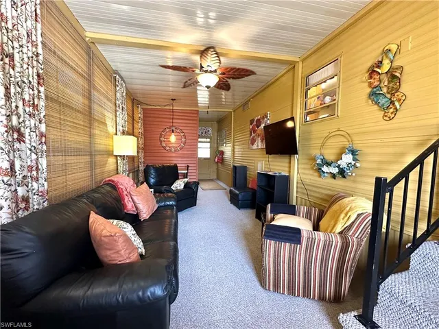 a living room with fireplace furniture and a flat screen tv